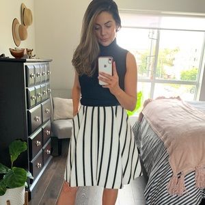 Black, white, tan pleated skirt